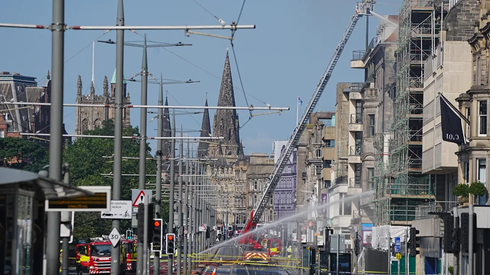 Firefighters on a high-rise platform tackling a blaze on Princes Street