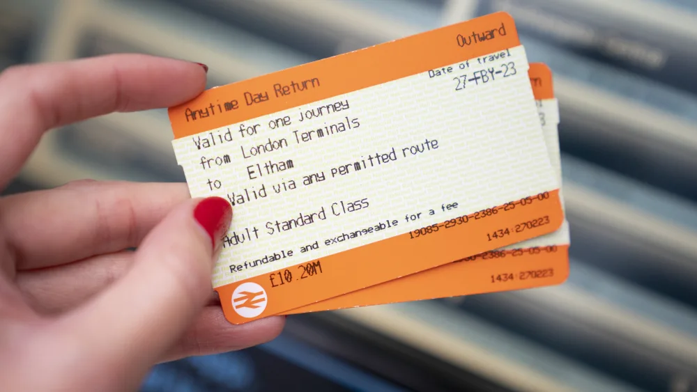A general view of a person holding train tickets