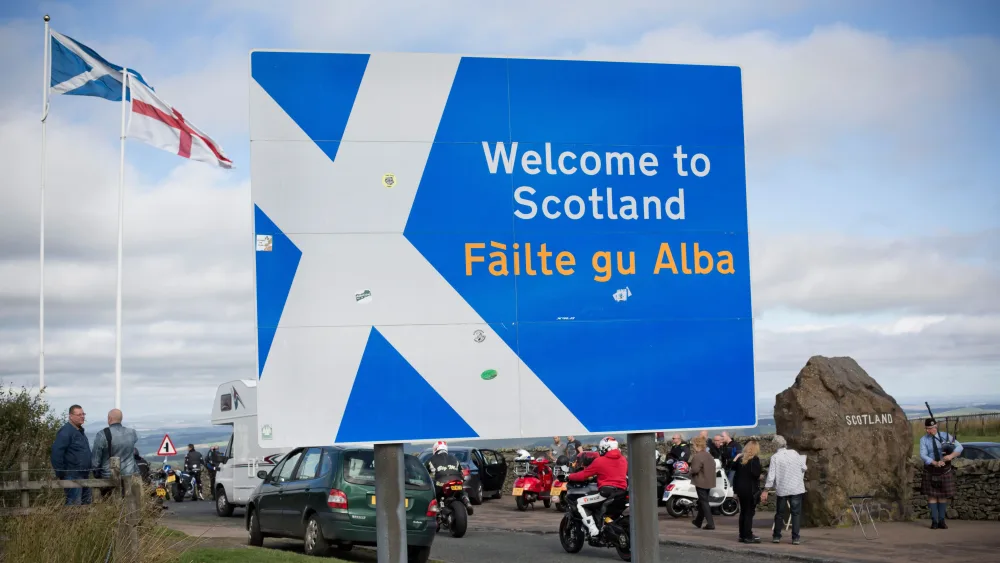 A view of a sign at the Scottish border, which is written in English and Gaelic