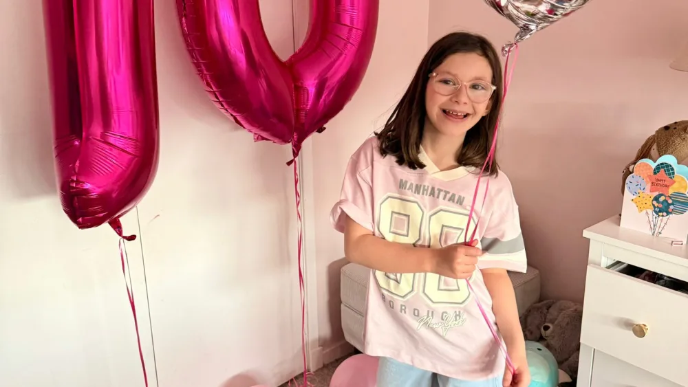 Romyn Winters beside a birthday balloon