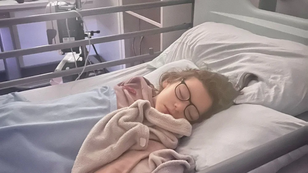 Romyn Winters in a hospital bed