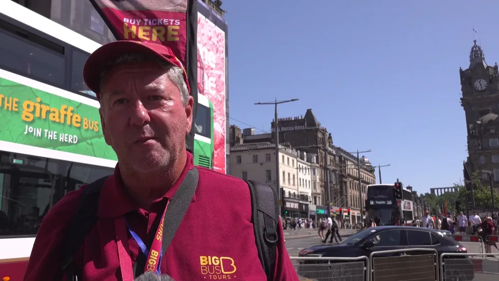 Allan Potts in front of an Edinburgh tourist bus