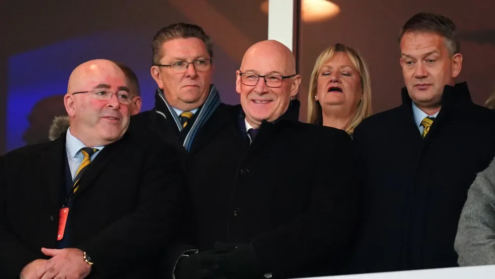 John Swinney and dignitaries watching Scotland versus Denmark