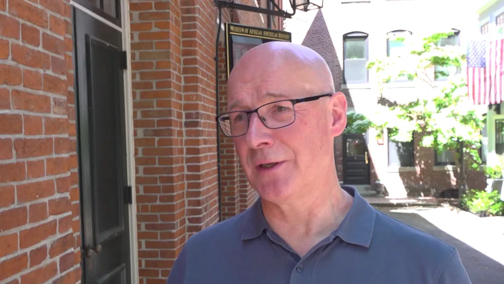 John Swinney talking to journalists in a Boston street