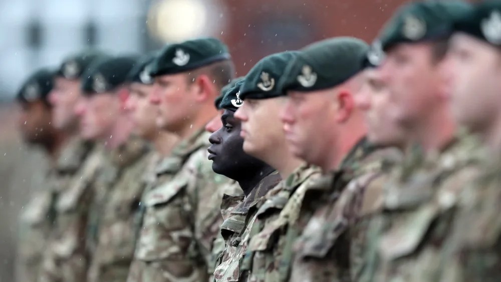 A view of Army personnel in uniform, standing in a line