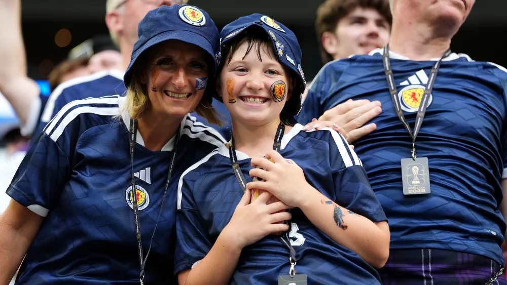 A woman and young boy in Scotland tops smiling