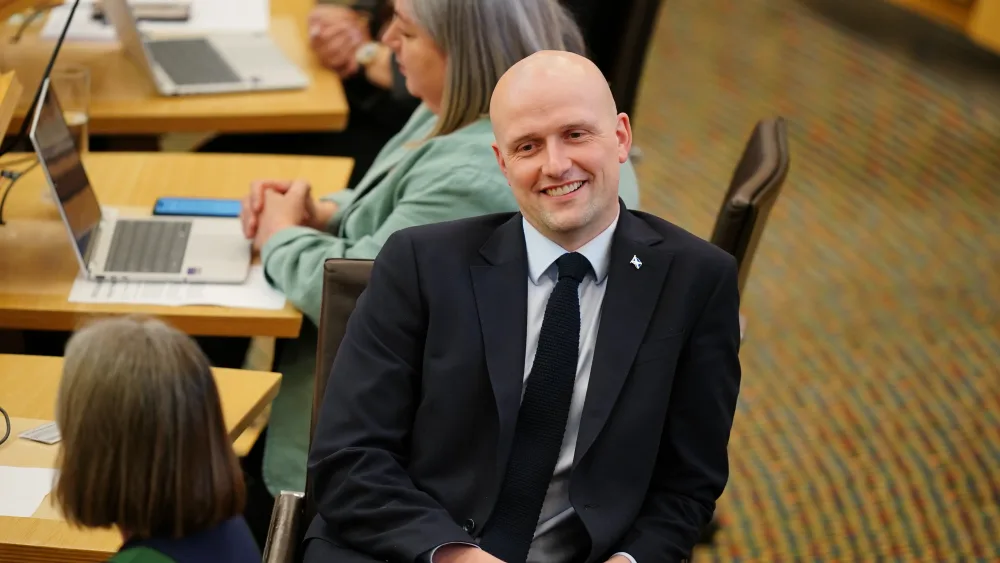 Stephen Flynn smiling while seated in Holyrood
