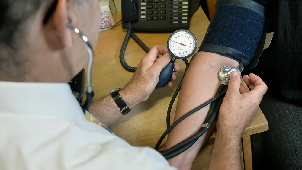 A doctor checking a patient's blood pressure