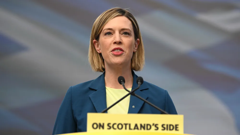 Jenny Gilruth speaking from an SNP lectern