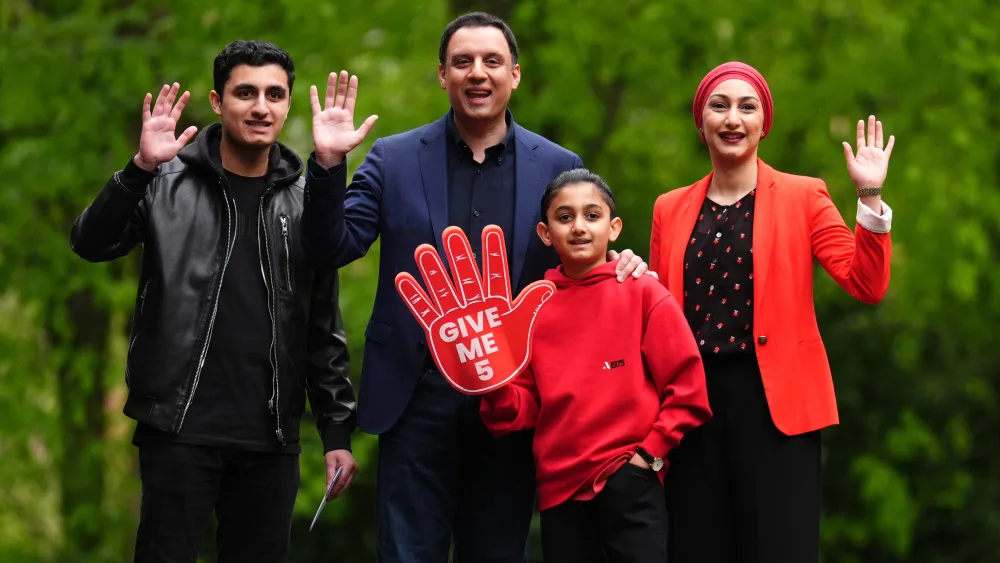 Anas Sarwar with his sons and wife, all waving