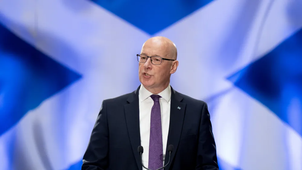 John Swinney, with a giant saltire in the background