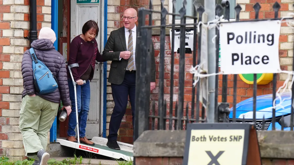 John Swinney and his wife Elizabeth exit a polling station
