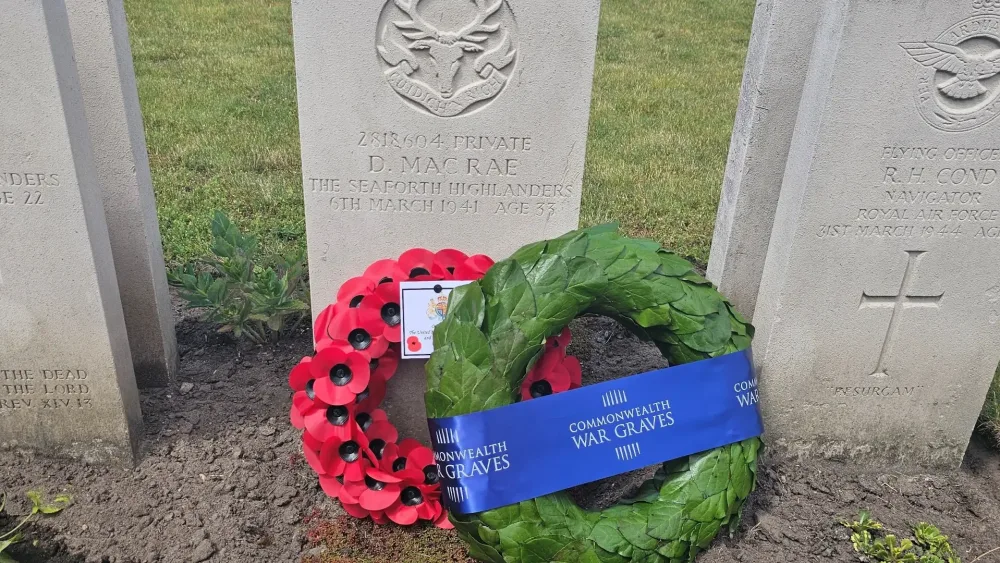 The headstone of Donnie MacRae with floral tributes