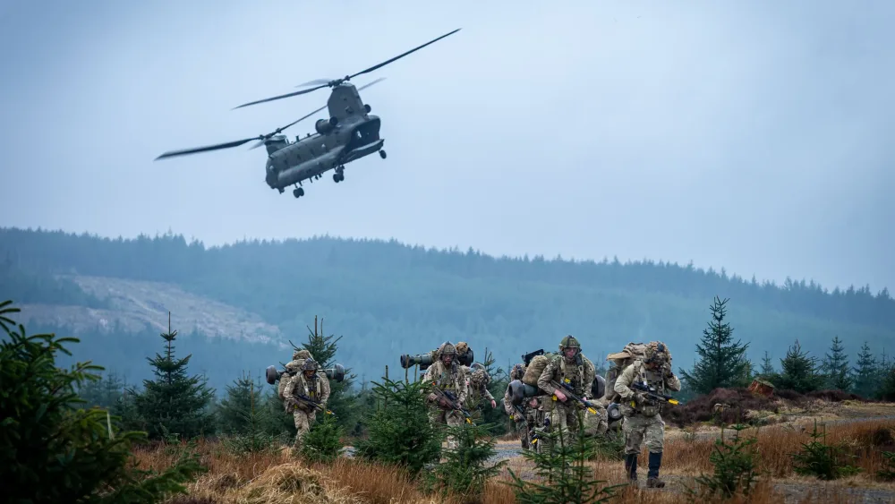 Troops on ground beneath Chinook helicopter