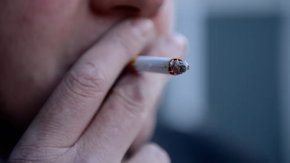 A man smokes a cigarette