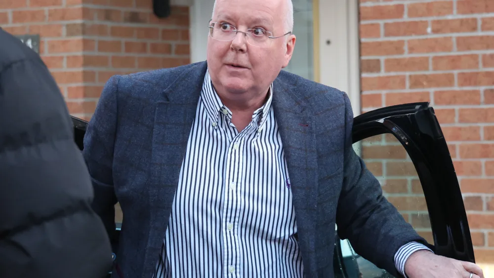 Peter Murrell exiting a car outside a house