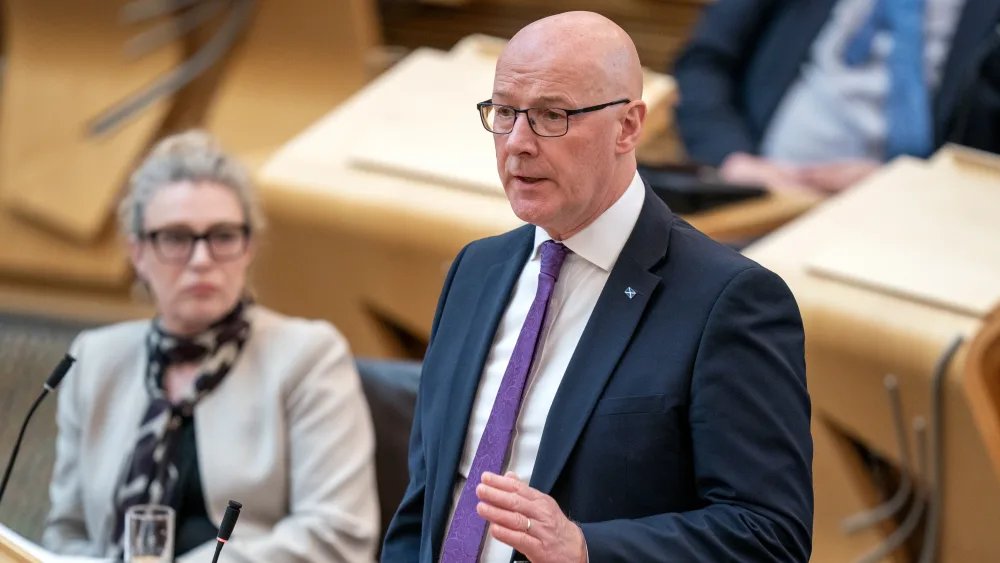 John Swinney standing while speaking in Holyrood