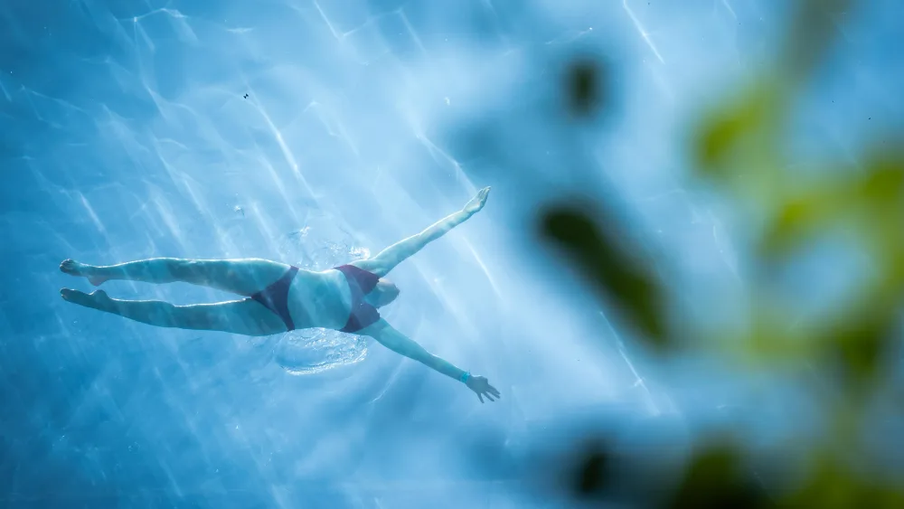 A person swimming in the sky pool in Nine Elms
