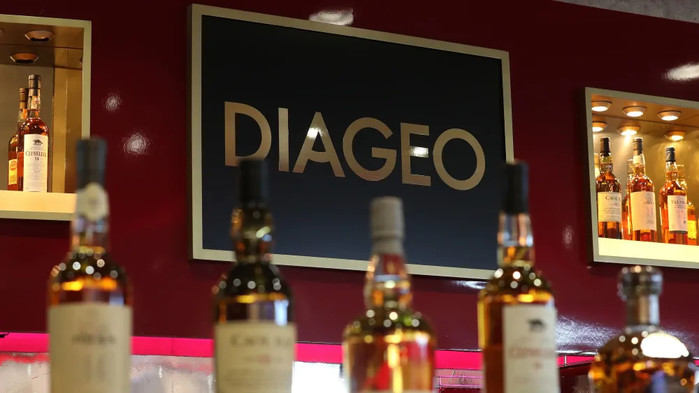 Bottles of alcohol in front of a Diageo sign