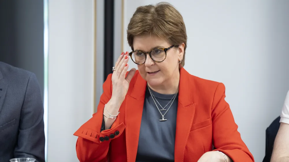 Nicola Sturgeon adjusting her glasses as she speaks