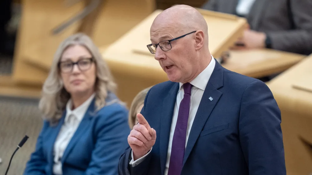 John Swinney standing while speaking in Holyrood