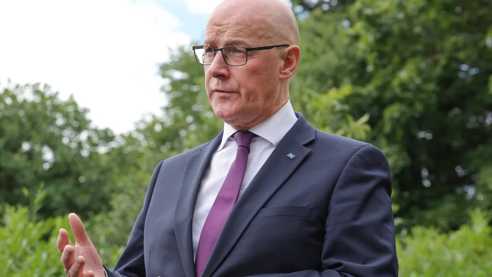 First Minister John Swinney speaks to the media