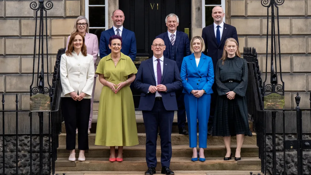 John Swinney and his Cabinet ministers posing for a group phone on the steps to Bute House