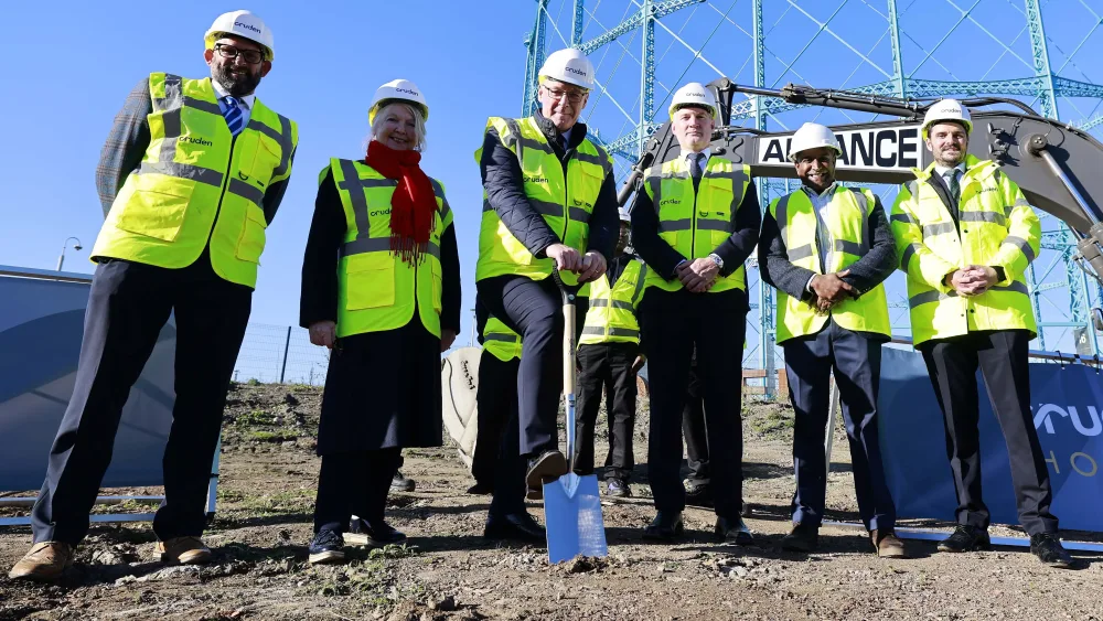 John Swinney using a shovel while posing for photos alongside a group of people