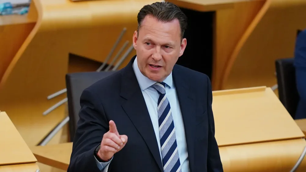Russell Findlay making a gesture in Holyrood