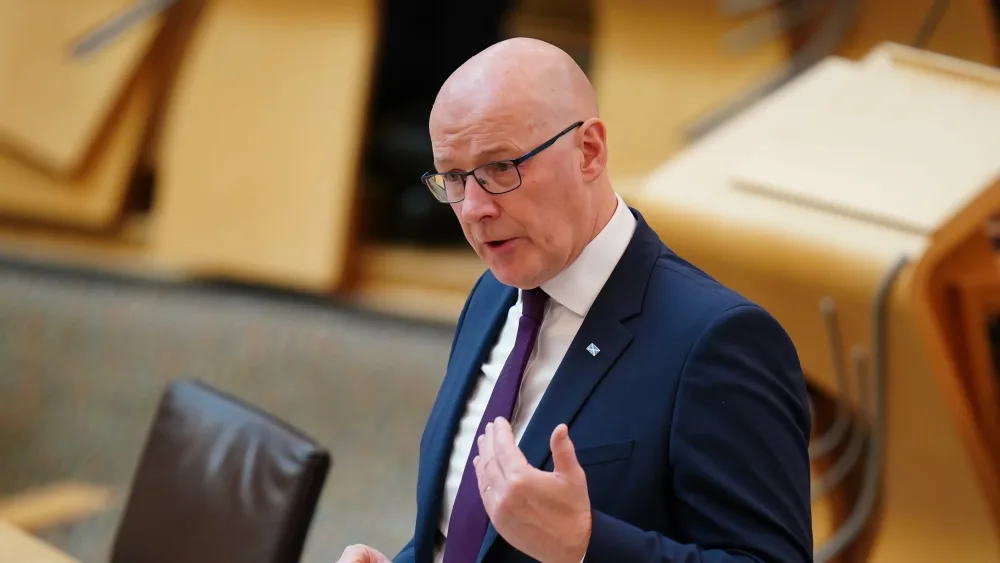 John Swinney standing while speaking in Holyrood