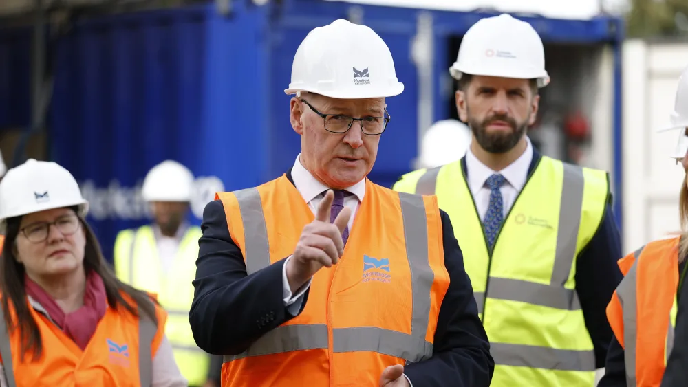 John Swinney and other people wearing hard hats and high-viz jackets