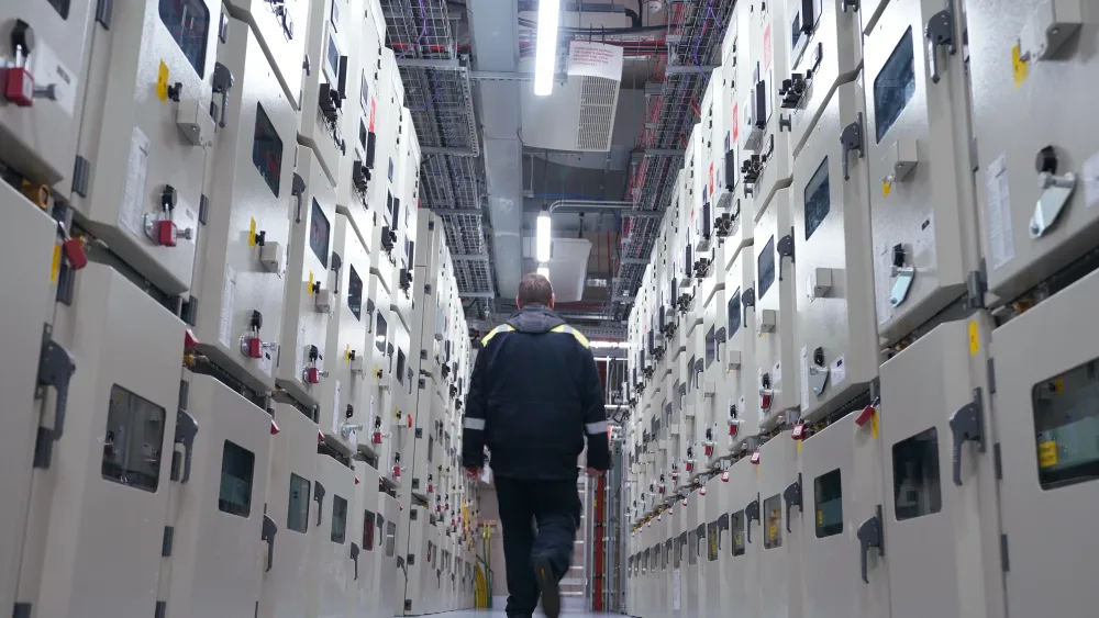 A man walking though a large data centre