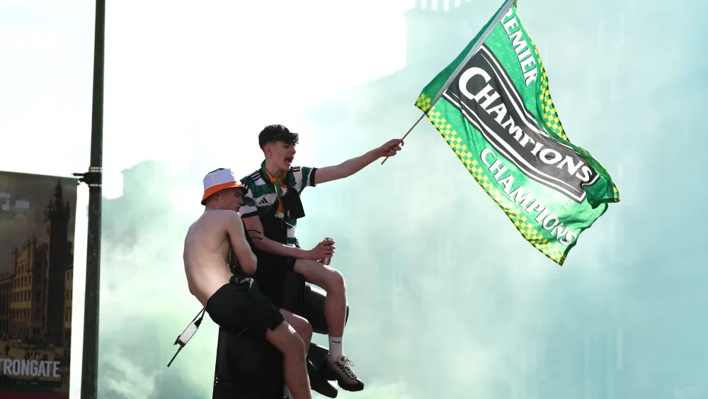 Celtic fans on top of a traffic light