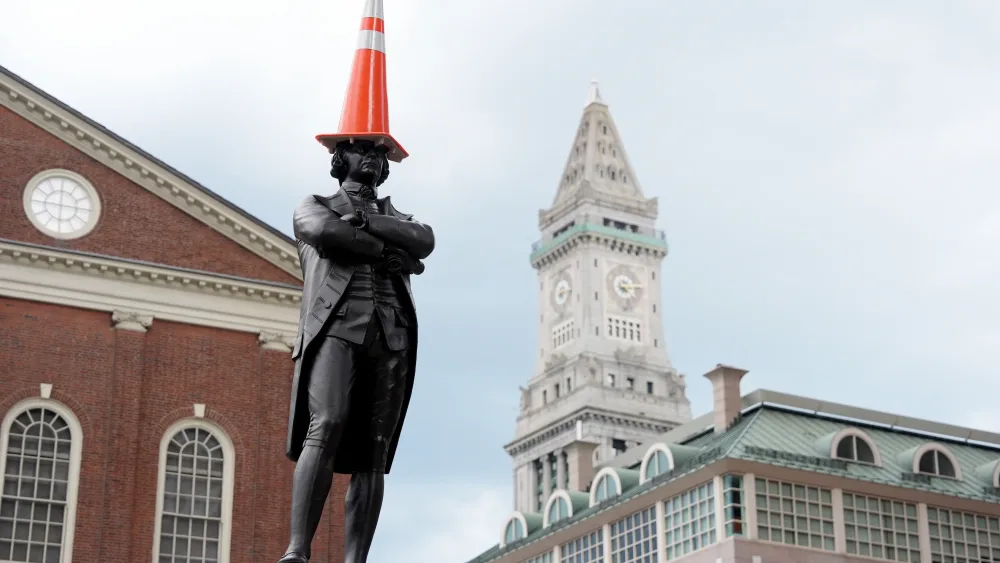 The Samuel Adams statue wears a traffic cone (Martin Rickett/PA)