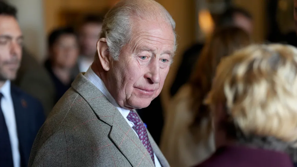 The King chatting to a woman, who has her back to the camera