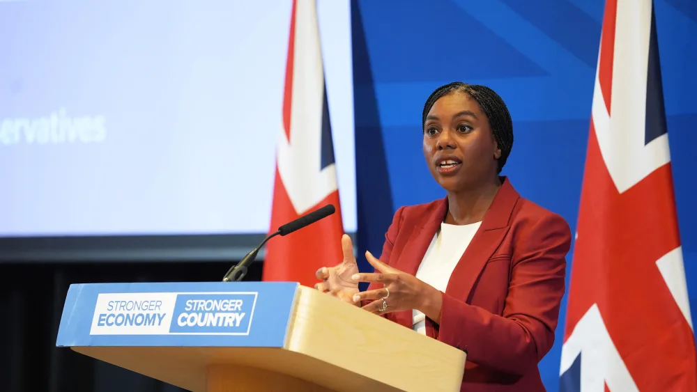 Kemi Badenoch speaking behind a lectern
