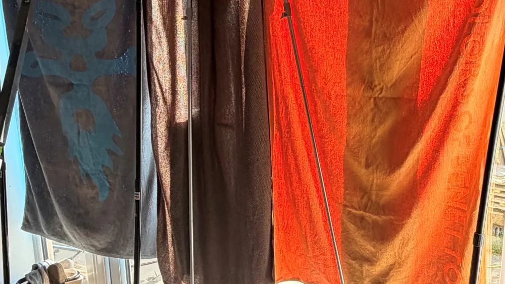Towels and blankets are used to block the sun coming through patio doors, so pets are kept cooler, at a home 