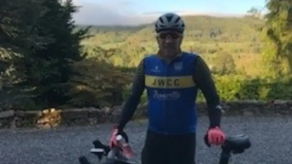 Iain McTavish standing beside his bike
