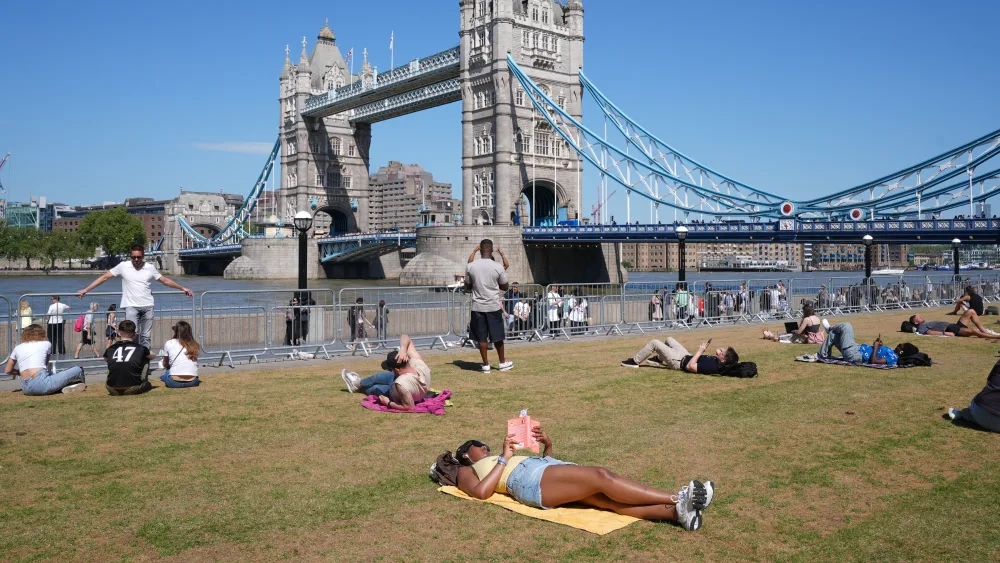 People relaxing in hot weather in Potters Fields Park, London